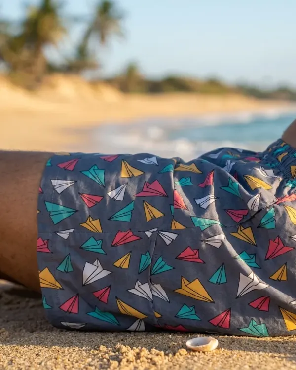 Whats Down grey paper-planes printed boxers. Close-up on the beach with the woven label