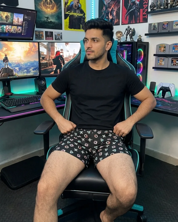 Man in a black tee and Whats Down printed cotton boxers in a gaming chair