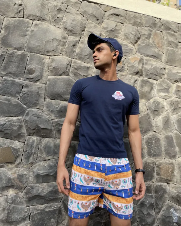 Man in a tee and Whats Down printed cotton boxers standing against a stone wall