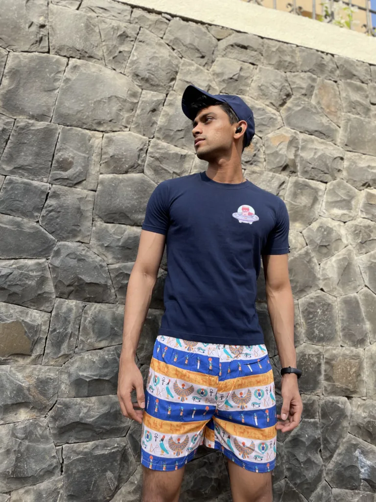 Man in a tee and Whats Down printed cotton boxers standing against a stone wall