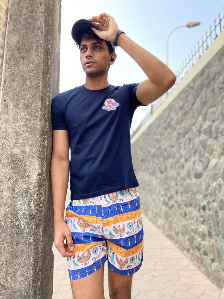 Man in a tee and Whats Down printed cotton boxers adjusting his cap in the sun