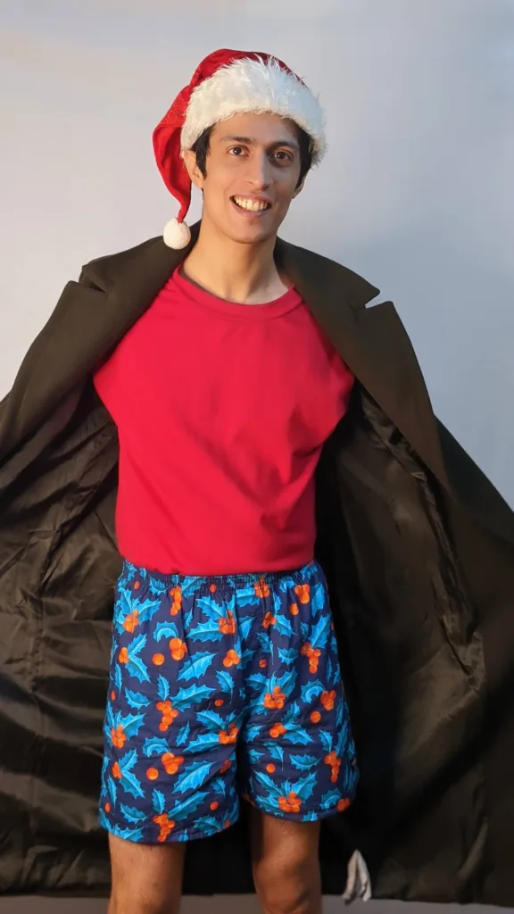 Man in Whats Down Blue Mistletoe printed boxers on a rooftop. Photo 1
