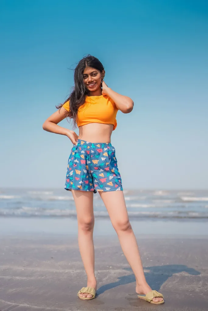 Woman at the beach in Whats Down Grey Paper Planes printed boxers. Photo 5