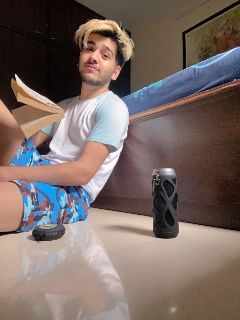 Man reading on the bed in Whats Down Blue Camo printed boxers. Photo 4