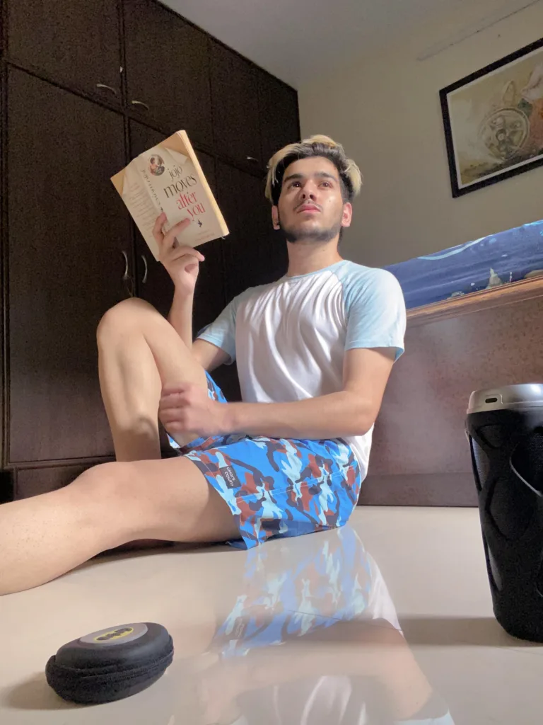 Man reading on the bed in Whats Down Blue Camo printed boxers. Photo 5