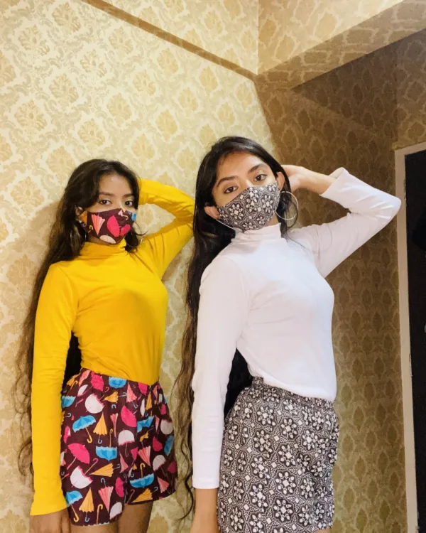 Two women in bright tops and Whats Down multicolour printed boxers indoors