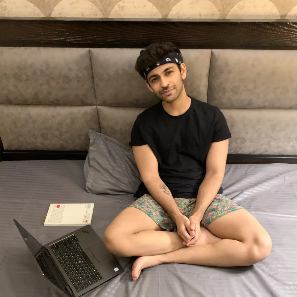 Man on the bed in Whats Down printed boxers with a laptop. Photo 1