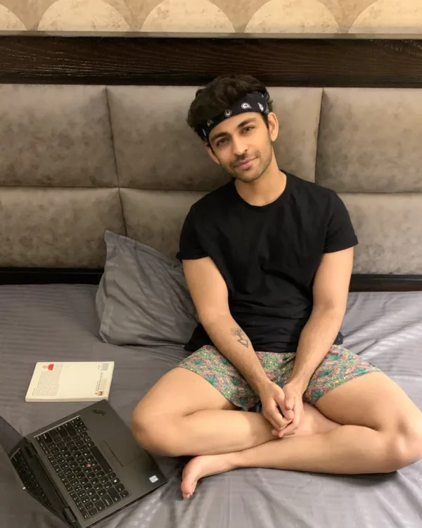 Man on the bed in Whats Down printed boxers with a laptop. Photo 1