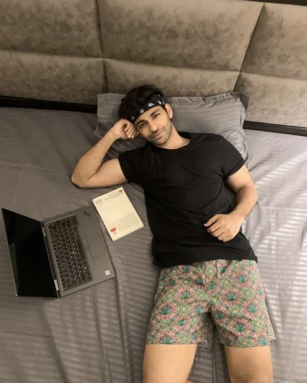 Man on the bed in Whats Down printed boxers with a laptop. Photo 2