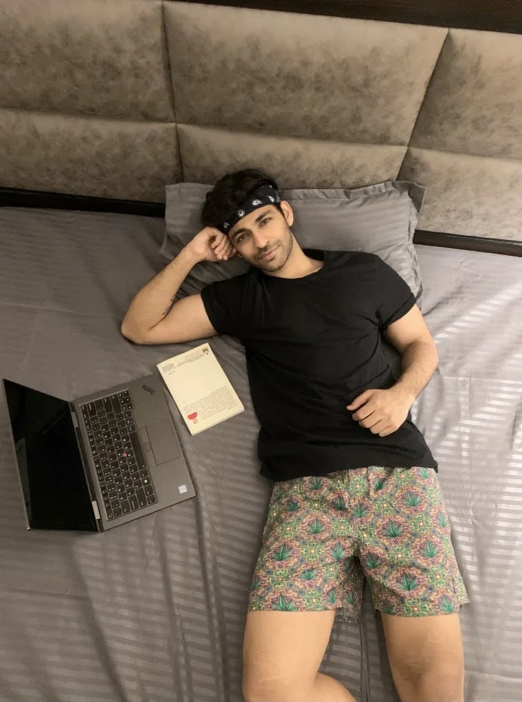 Man on the bed in Whats Down printed boxers with a laptop. Photo 2